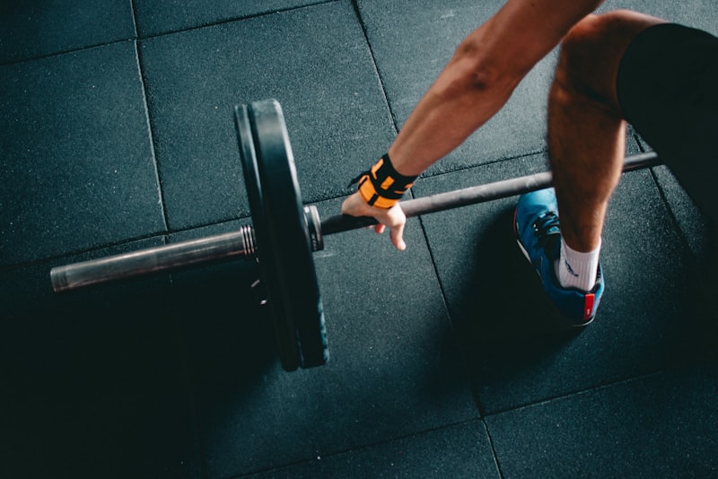 A lifter setting up at a barbell, checking their stance before a rep