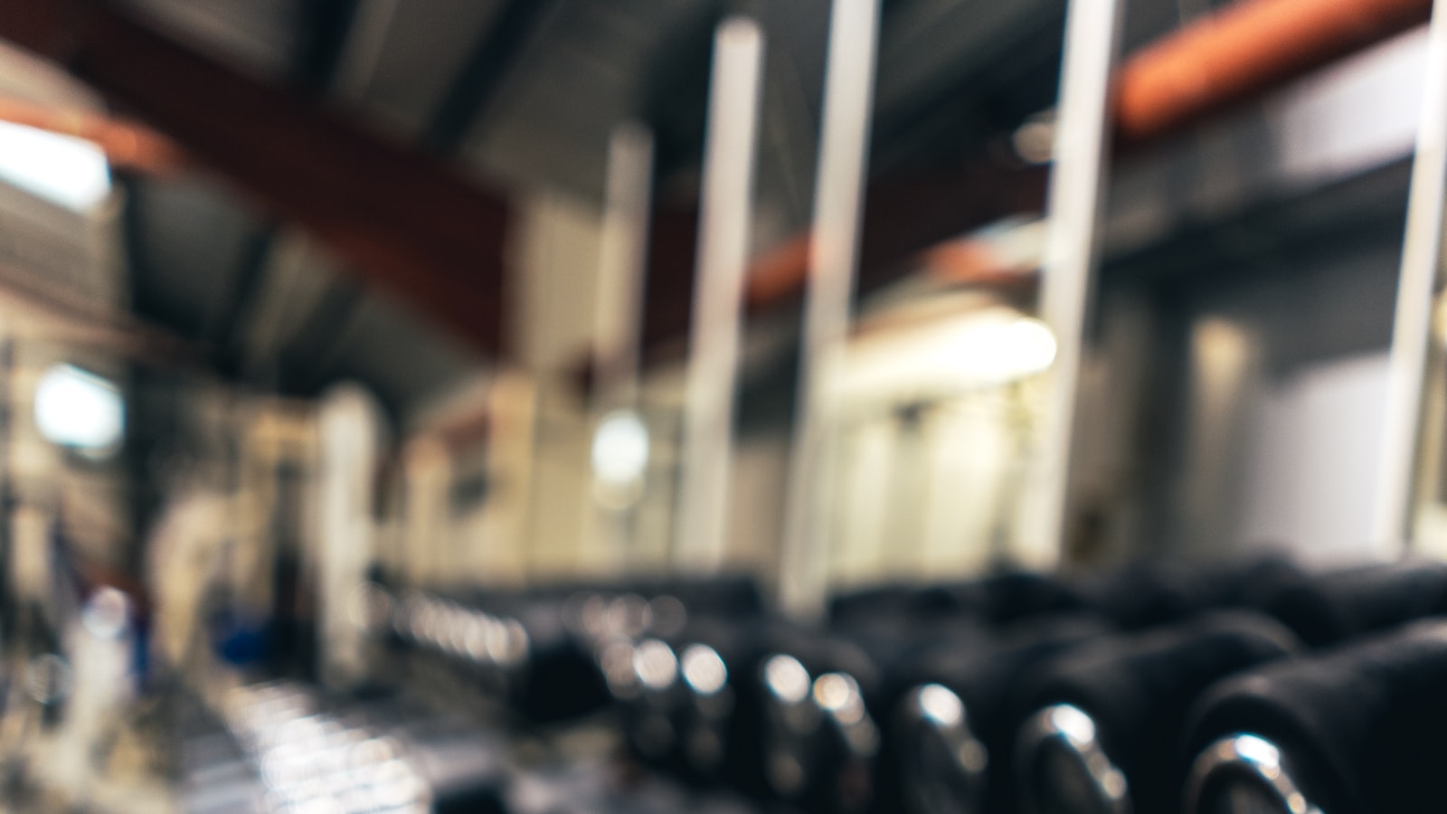 A person warming up carefully before a workout in a bright gym, taking their time