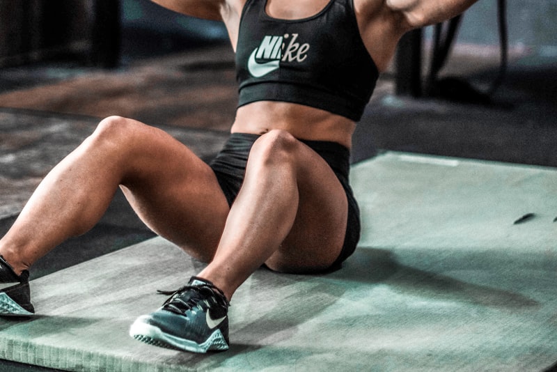 Stacked weight plates and dumbbells arranged on a gym rack, ready for a training session.